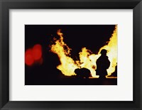 Framed Firefighters In front Of Flames Extinguishing A Fire