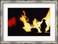 Framed Firefighters In front Of Flames Extinguishing A Fire
