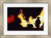 Framed Firefighters In front Of Flames Extinguishing A Fire