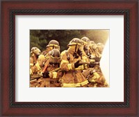 Framed Group of firefighters spraying water with a fire hose