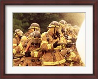 Framed Group of firefighters spraying water with a fire hose