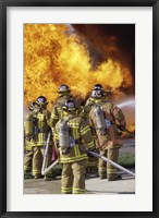 Framed Rear view of a group of firefighters extinguishing a fire vertical