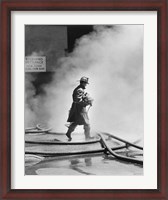 Framed Firefighter walking in front of smoke