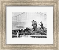 Framed Three firefighters extinguishing a fire