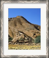 Framed Tourists climbing on a rock, Ayers Rock, Uluru-Kata Tjuta National Park, Australia