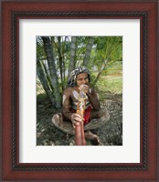 Framed Aborigine playing a didgeridoo, Cairns, Queensland, Australia