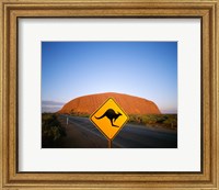 Framed Kangaroo sign on a road with a rock formation in the background, Ayers Rock