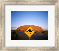 Framed Kangaroo sign on a road with a rock formation in the background, Ayers Rock