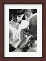 Framed Male doctor listening to a boy's heartbeat