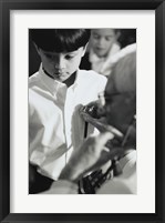 Framed Male doctor listening to a boy's heartbeat