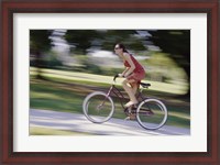 Framed Side profile of a young woman riding a bicycle