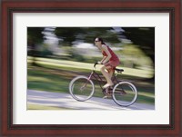 Framed Side profile of a young woman riding a bicycle
