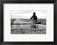 Framed Rear view of a girl riding a bicycle