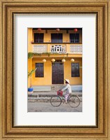 Framed Person riding a bicycle in front of a cafe, Hoi An, Vietnam