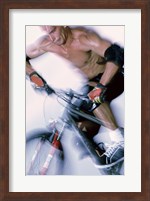 Framed Close-up of a young man riding a bicycle