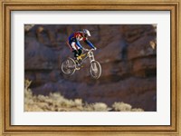 Framed Side profile of a person on a bicycle in mid air