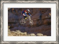 Framed Side profile of a person on a bicycle in mid air