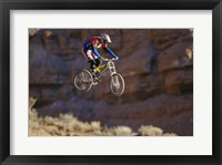 Framed Side profile of a person on a bicycle in mid air