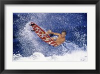 Surfing in action Framed Print