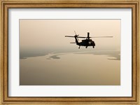 Framed Air Force helicopter flys over Lake Pontchatrain to New Orleans