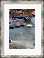 Framed Blackhawk helicopter drops sandbags into an area where the levee broke due to Hurricane Katrina