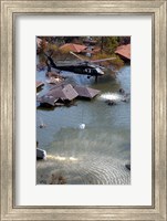 Framed Blackhawk helicopter drops sandbags into an area where the levee broke due to Hurricane Katrina