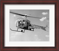 Framed Low angle view of two people sitting in a helicopter, Bell 47G-2