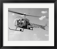 Framed Low angle view of two people sitting in a helicopter, Bell 47G-2