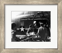 Framed Army soldiers carrying an injured person in a helicopter