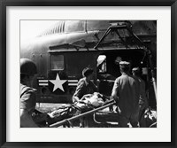 Framed Army soldiers carrying an injured person in a helicopter
