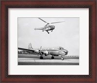 Framed Low angle view of a helicopter in flight and an airplane at an airport, Sikorsky Helicopter, Douglas DC-4