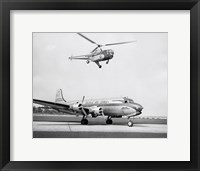 Framed Low angle view of a helicopter in flight and an airplane at an airport, Sikorsky Helicopter, Douglas DC-4