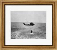 Framed Marine helicopter lifting the astronaut spacecraft out of the Ocean