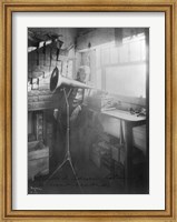 Framed Thomas Alva Edison, full-length portrait, standing, facing right, listening to a new record