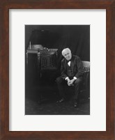 Framed Thomas Edison, seated beside phonograph