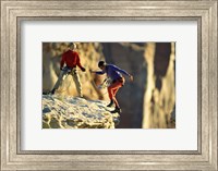 Framed Two hikers with ropes at the edge of a cliff