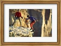 Framed Two hikers with ropes at the edge of a cliff