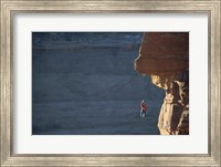 Framed Man hanging from a rope on the edge of a cliff