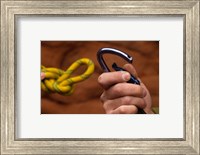 Framed Close-up of human hands holding a carabiner and rope