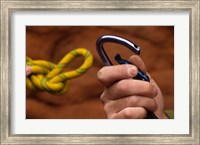 Framed Close-up of human hands holding a carabiner and rope