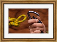 Framed Close-up of human hands holding a carabiner and rope