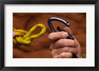 Framed Close-up of human hands holding a carabiner and rope