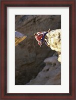 Framed High Angle View of a Man hanging off of a Summit
