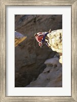 Framed High Angle View of a Man hanging off of a Summit