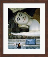 Framed Monk Sitting in Front of a Buddha Statue