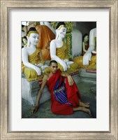 Framed Monk Sitting in Front of a Buddha Statue