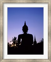 Framed Silhouette of Buddha and temple during sunset, Sukhothai, Thailand