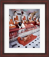 Framed Monk Sleeping in Front of Buddha Statues