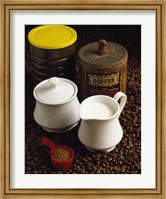 Framed Close-up of a mug of milk with a measuring spoon and jars on coffee beans