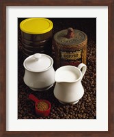 Framed Close-up of a mug of milk with a measuring spoon and jars on coffee beans